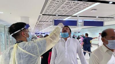 Saudi medical staff give oral medication to the first batch of Muslims from international flights on their way to Umrah. Reuters
