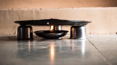 Three steel bowls are arranged in a triangular form that acts as a stand for this plate.