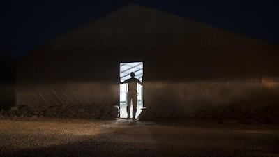 An Iraqi army soldier stands at the entrance of a tent at the Qayara air base, south of Mosul. Felipe Dana / AP Photo
