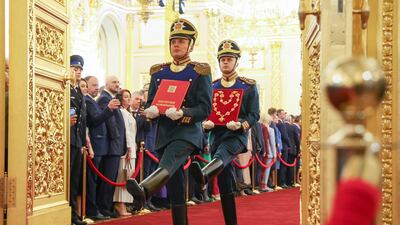 Presidential regiment guards carry a gold-embossed copy of the Russian Constitution and the presidential chain of office. AP