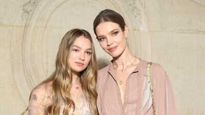 Natalia Vodianova (R) and her daughter attend the Christian Dior show (Photo by Pascal Le Segretain/Getty Images)