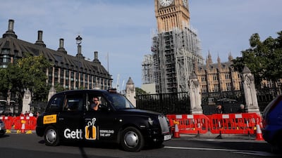 A black taxi passes the Houses of Parliament in London, Britain September 24, 2017. REUTERS/Eddie Keogh