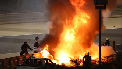 Fire marshals try to put out the fire after Haas driver Romain Grosjean's crash during the Bahrain Formula One Grand Prix in Sakhir on Sunday, November 29. AFP