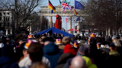People gather at Brandenburg Gate to see the royal welcome ceremony. Reuters