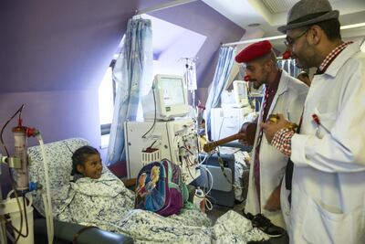 Clowns entertain Palestinian patient Shaheed Siam,11, from Ramallah.