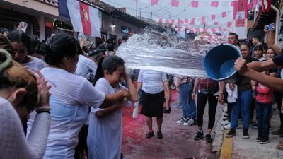 Participants are doused with water as they pass through the religious procession at the Traditional Festival of San Jeronimo in Veracruz, Mexico. Getty Images