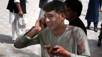 A man who has shifted an injured victim of bomb blasts, react outside a hospital in Jalalabad, Afghanistan, on May 13, 2018. Ghulamullah Habibi / EPA