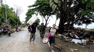 Residents evacuate from damaged homes on Carita beach. AFP