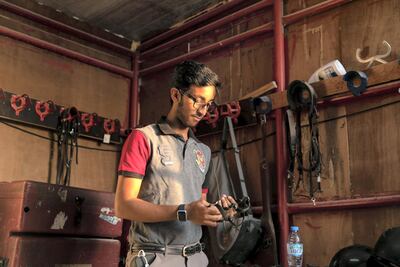 Omar Al Marzooqi preps for a ride at Al Bahiya Stables. Al Marzooqi says his feet remain rooted to the ground despite his early success. Reem Mohammed / The National