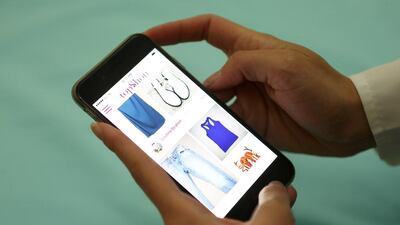 Loubna Ibrahim, co-founder of a new app called TopShou using the app on the phone at her home. Pawan Singh / The National