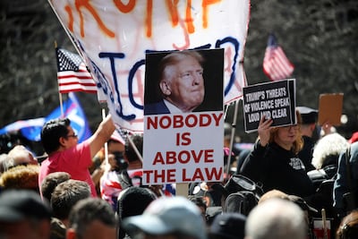 Trump opponents outside Manhattan Criminal Court during his arraignment in April. AFP