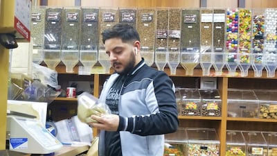 Jamal Hashem mixes a bag of zataar at his family's store in Dearborn, Detroit. Courtesy Stephen Starr
