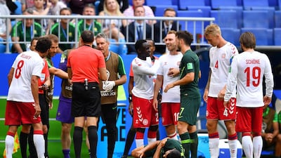 Australia's Andrew Nabbout is on the floor after sustaining an injury as Denmark's Christian Eriksen looks on. Dylan Martinez / Reuters