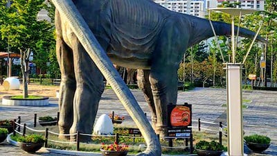 A dinosaur sculpture is damaged by Typhoon Maysak in Ulsan. AFP