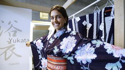 A woman wearing Japanese summer kimono, or yukata, poses at the Japan House. Kyodo