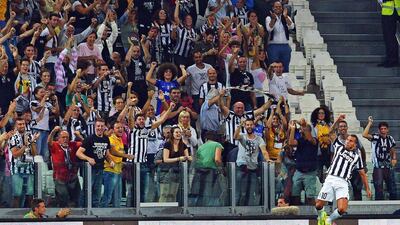 Juventus' Carlos Tevez celebrates after scoring their opening goal in a 2-0 win over Udinese on Saturday. Di Marco / EPA / September 13, 2014