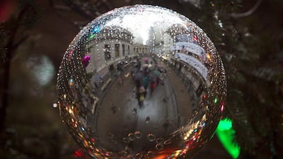 USA: The exterior of the New York Stock Exchange is reflected in a Christmas ornament in New York. Reuters/Carlo Allegri