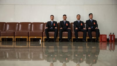 Security officers are reflected in the shining floor during the closing ceremony of the 19th National Congress of the Communist Party of China (CPC) in Beijing. Roman Pilipey / EPA