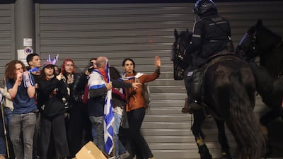 Mounted police disperse protesters in Tel Aviv. AP