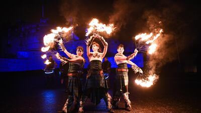 Three members of PyroCeltica perform at the start of the Hogmanay celebrations. Getty