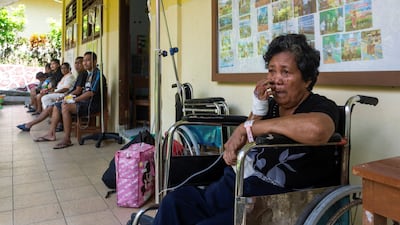 Patients sit at a school in the North Sulawesi province of Indonesia after being evacuated from hospital. Reuters