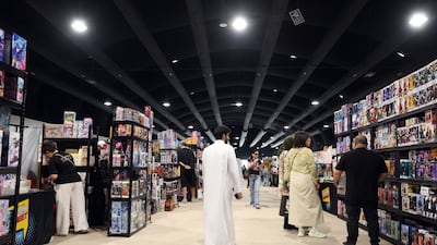 Visitors browse rows of figures and collectibles at Playgrounds, a community-led pop culture event in Abu Dhabi. Chris Whiteoak / The National