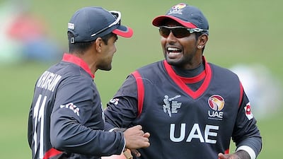 UAE players Khurram Khan, left, and Krishna Karatechat during their Cricket World Cup Pool B match against the West Indies in Napier, New Zealand, Sunday, March 15, 2015. Ross Setford / AP Photo