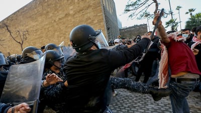 Lebanese policemen and students at the American University of Beirut (AUB) clash during a protest in front of the university over an effective tuition fee hike caused by the changing of the exchange rate from Lebanese lira to US dollar. EPA