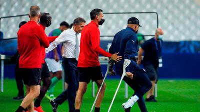 Kylian Mbappe walks with crutches. AFP