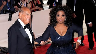 Oprah Winfrey wears a navy silk Oscar de la Renta gown with a voluminous skirt to arrive at the 2010 Met Ball with designer Oscar de la Renta on May 3, 2010. EPA