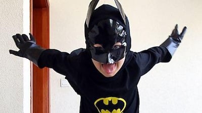 Dylan, 4, plays Batman at his home in Dubai. Engaging in the imaginary world of superheroes can give children more confidence. Satish Kumar / The National