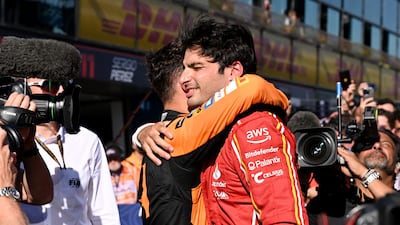 Carlos Sainz embraces McLaren's Lando Norris after both drivers finished on the podium. Reuters