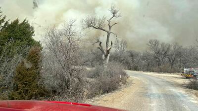 Smoke from a fire in the Texas panhandle billows over a road. AP