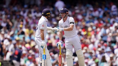 England’s Joe Root, left, and Harry Brook fist bump on day one of the fifth Ashes Test at the Sydney Cricket Ground. PA