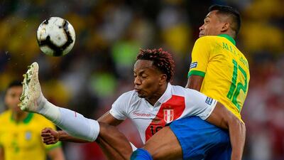 Peru's Andre Carrillo and Brazil's Alex Sandro vie for the ball. AFP