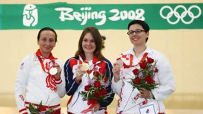 Katerina Emmons, centre, of Czech Republic celebrates winning the gold medal in the women's 10m air rifle with the silver medallist Lyubov Galkina, left, of Russia and bronze medallist Snjezana Pejcic of Croatia.