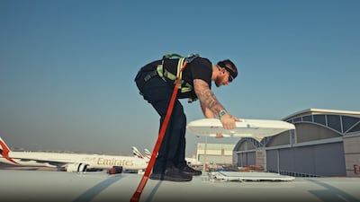 An Emirates airline engineer installs Starlink Wi-Fi to a jet. Photo: Emirates