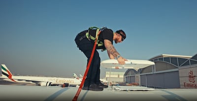An Emirates engineer installs Starlink Wi-Fi to a jet. Photo: Emirates