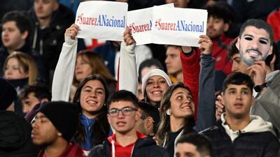 Nacional fans with Luis Suarez posters. AFP