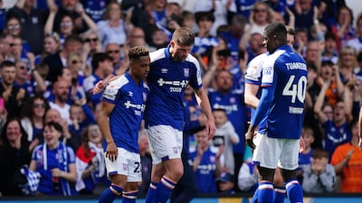 Ipswich Town's Omari Hutchinson, left, celebrates with teammates after scoring their second goal. PA