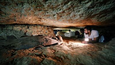 Egyptian antiquities worker is seen inside the recently discovered burial site in Minya, Egypt. Mohamed Abd El Ghany / Reuters
