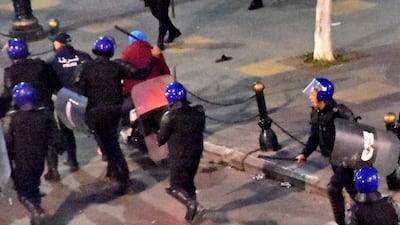Algerian security forces rush towards demonstrators during an anti-government demonstration on, in the capital Algiers on the day of the presidential election. About 10,000 protesters rallied in Algeria's capital against presidential elections they believe aim to perpetuate the regime of deposed leader Abdelaziz Bouteflika, AFP reporters witnessed. AFP