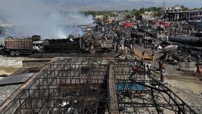 Local residents and owners of fuel tankers inspect the debris following an overnight ablaze in which several fuel tankers caught fire at Qala-e-Murad Bek area on the outskirts of Kabul. AFP