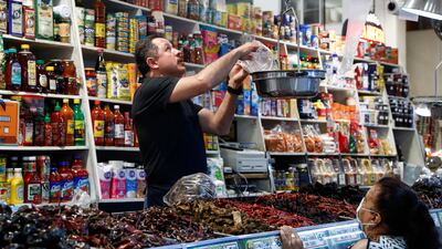Spices are weighed for a customer at a stand at Grand Central Market in Los Angeles, California. The US Federal Reserve has a goal of bringing inflation down to its 2 per cent target range after prices hit a four-decade high in June 2022. EPA