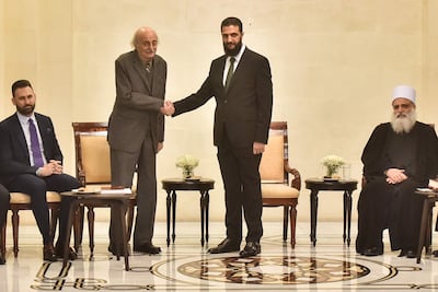 Walid Jumblatt, the Druze former leader of Lebanon's Progressive Socialist Party (PSP), shakes hands with Syrian leader Ahmad Al Shara during a visit to Damascus. AFP