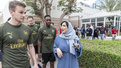 Mariam Othman escorts Arsenal FC and Al Nasr players around the centre