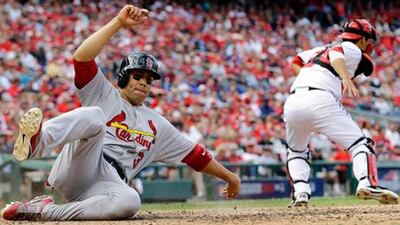 St Louis Cardinals' Carlos Beltran slides home past Kurt Suzuki of the Washington Nationals