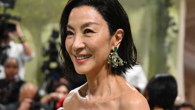 Michelle Yeoh in Cindy Chao earrings and watch, wearing silver Balenciaga. AFP