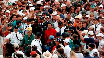 Tiger Woods is engulfed by the gallery as he makes his way to the the 18th hole during final round at the 1997 US Masters. AP Photo