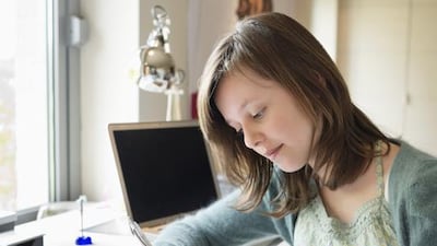 Encouraging your child to keep a journal is one way to get them back into the habit of writing regularly. Eric Audras/Onoky/Corbis